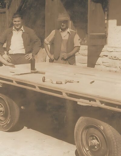 Photograph in sepia colours of a trailer and the owner and managing director of the Schwarz company